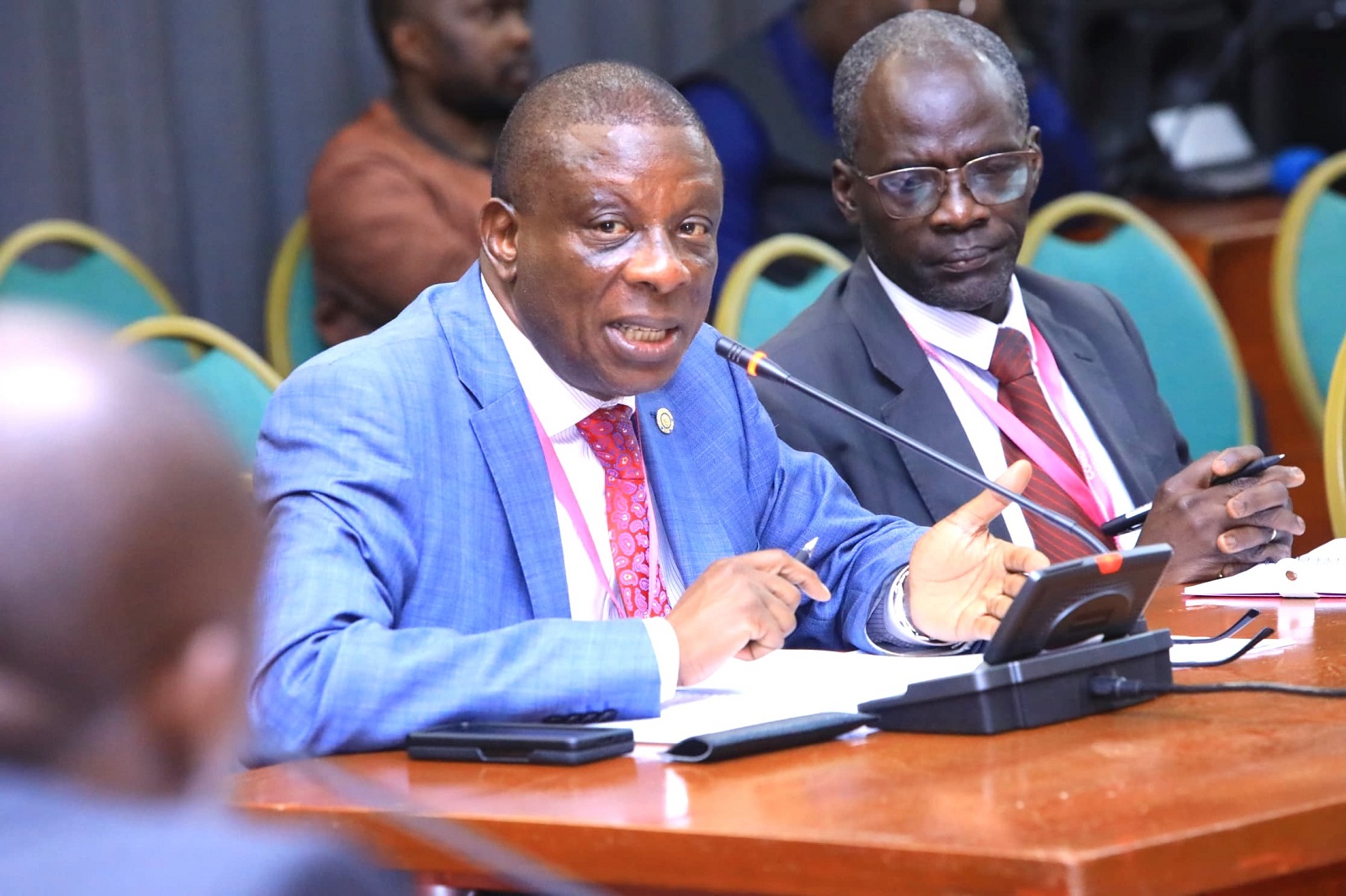 The Electoral Commssion's Richard Kamugisha (left) before the committee